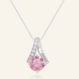 A silver necklace featuring a stunning 1-carat round pink moissanite centerpiece, accented with a graceful curved design adorned with sparkling cubic zirconias.