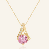 A yellow gold necklace featuring a stunning 1-carat round pink moissanite centerpiece, accented with a graceful curved design adorned with sparkling cubic zirconias.