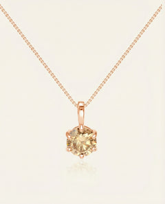 Close-up of the InfinityOne Classic Moissanite Necklace | Champagne in rose gold, resting on a warm linen background