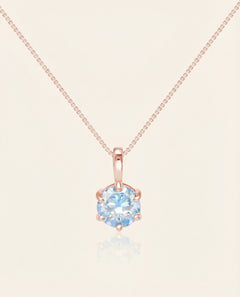 Close-up of the InfinityOne Classic Moissanite Necklace | Ice Blue in rose gold, resting on a warm linen background