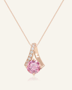 Close-up of the 1ct Pink Moissanite Necklace in rose gold, resting on a warm linen background