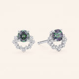 Pair of Starlight Crown Crescent Moissanite Stud Earrings in sterling silver with round Celestial Teal moissanite stones and pavé arc frames.
