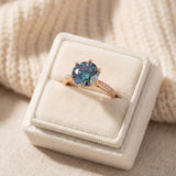 3 Carat Mystic Moissanite Ring in rose gold, laid flat on a tabletop