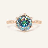 Close-up of the 3 Carat Mystic Moissanite Ring in rose gold, resting on a warm linen background