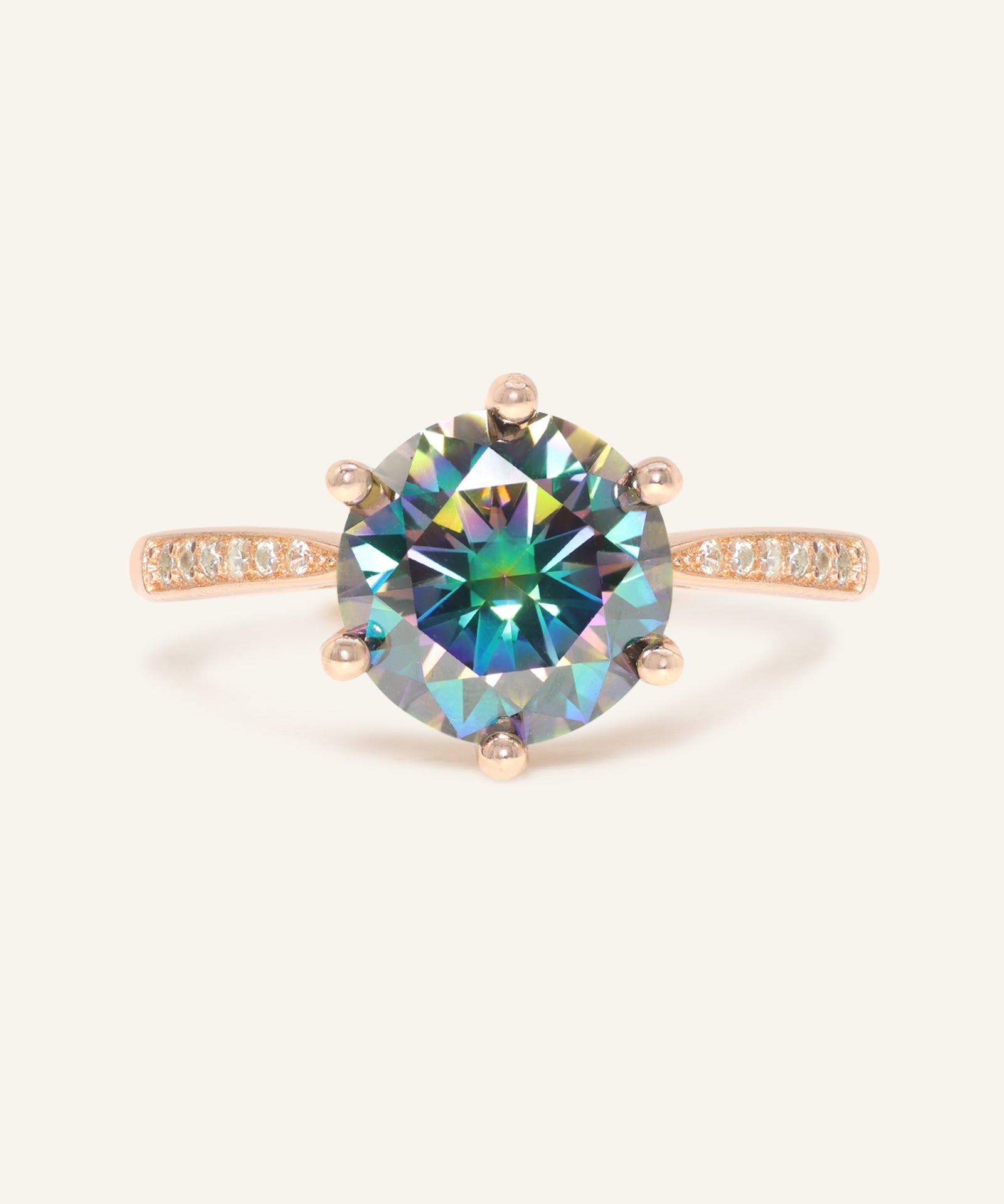 Close-up of the 3 Carat Mystic Moissanite Ring in rose gold, resting on a warm linen background