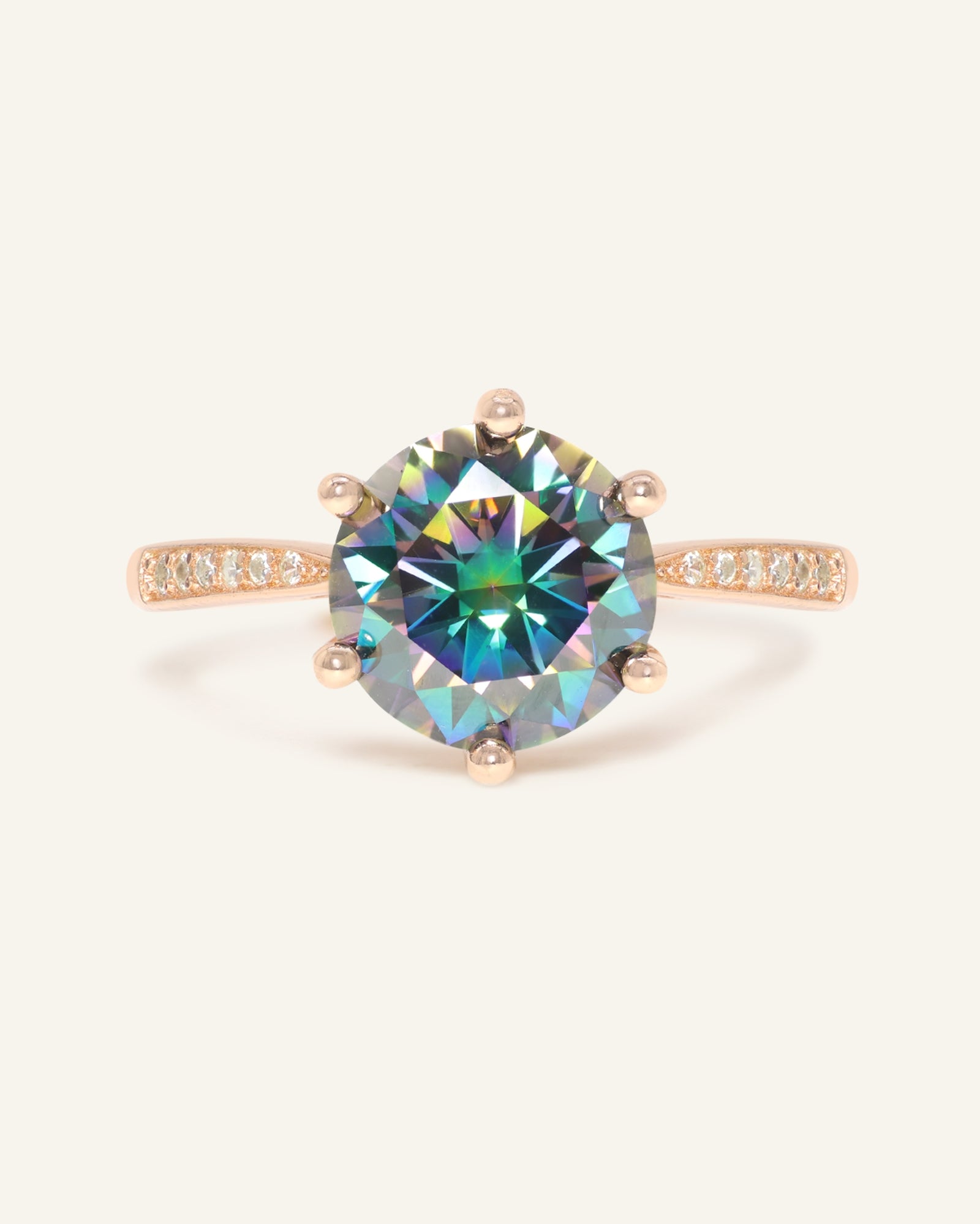 Close-up of the 3 Carat Mystic Moissanite Ring in rose gold, resting on a warm linen background