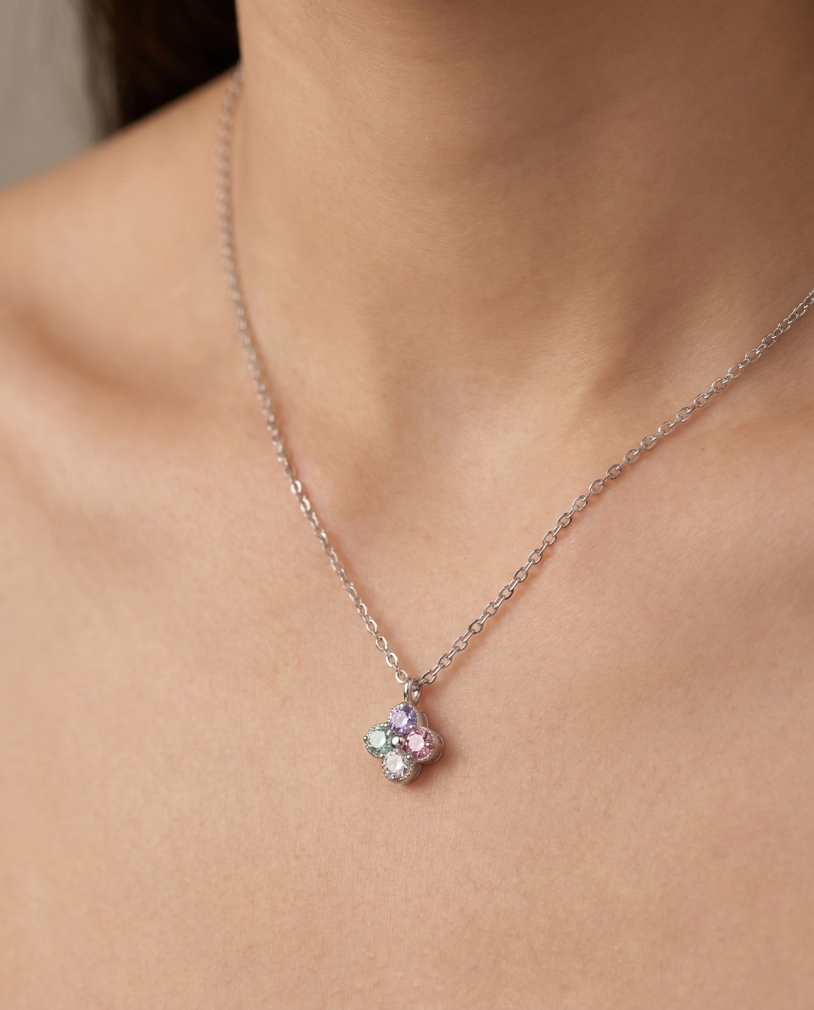 Front view of the Tale of Two Clovers pendant in silver, worn by a model to show everyday scale and fit.