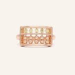 A rose gold abacus ring featuring a rectangular frame with golden beads and yellow citrine stones, designed to mimic a traditional abacus, adding a playful and unique touch to your jewelry collection.