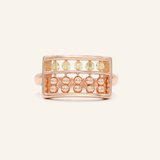 A rose gold abacus ring featuring a rectangular frame with golden beads and yellow citrine stones, designed to mimic a traditional abacus, adding a playful and unique touch to your jewelry collection.