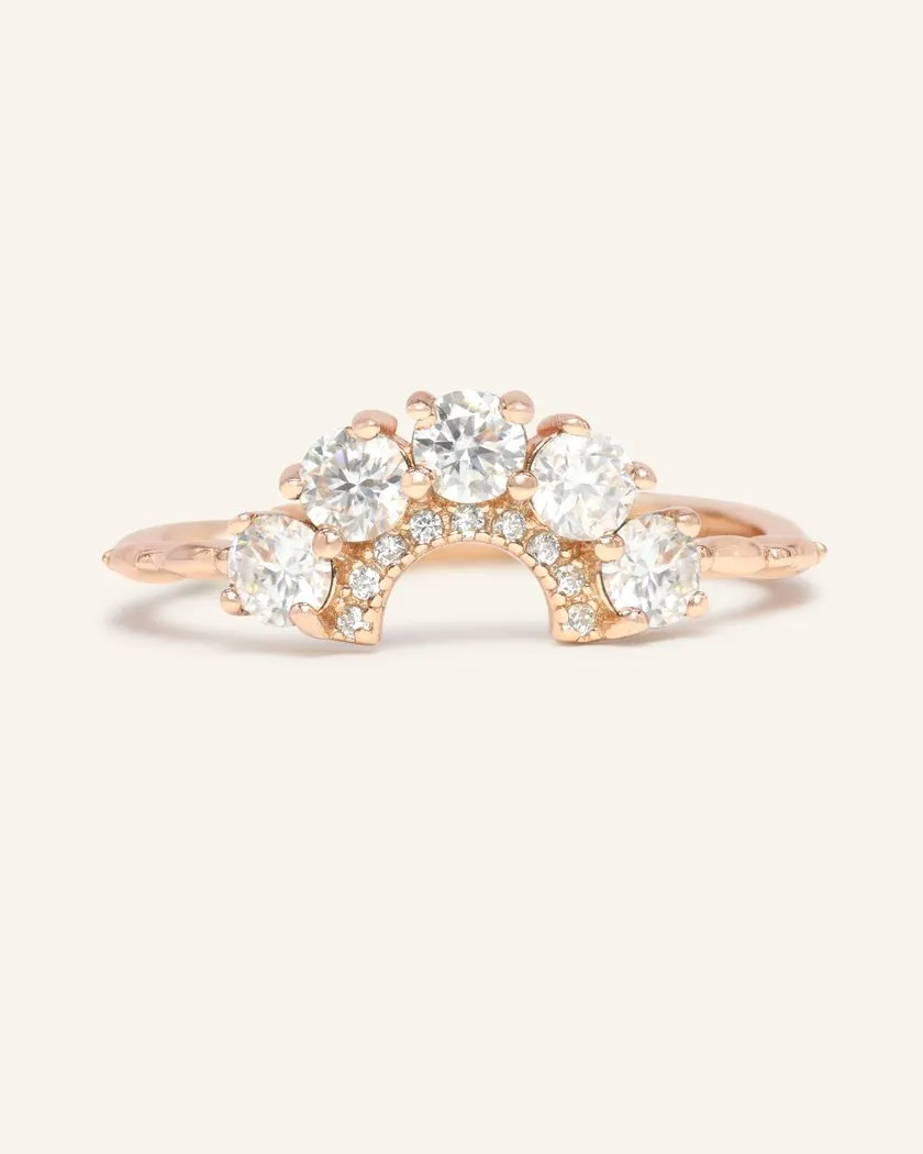 Arc White Moissanite Ring in rose gold featuring a delicate arc design set with brilliant white moissanite gemstones.