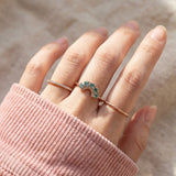 Arc Green Moissanite Ring in rose gold, worn on a model