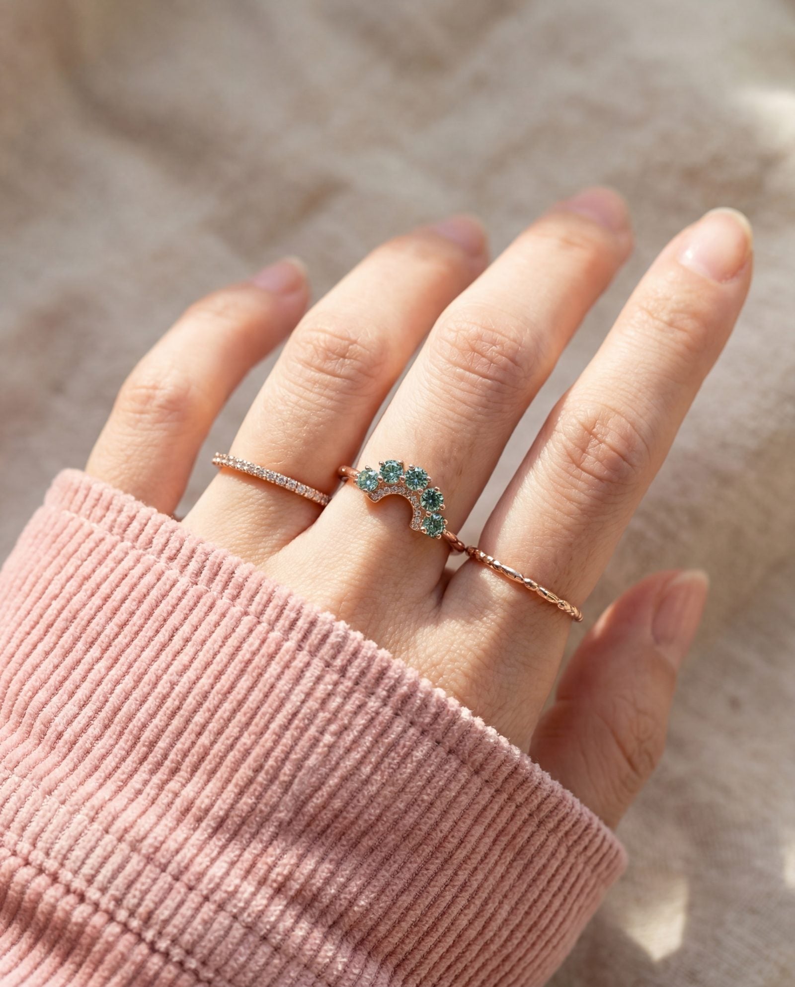 Arc Green Moissanite Ring in rose gold, worn on a model