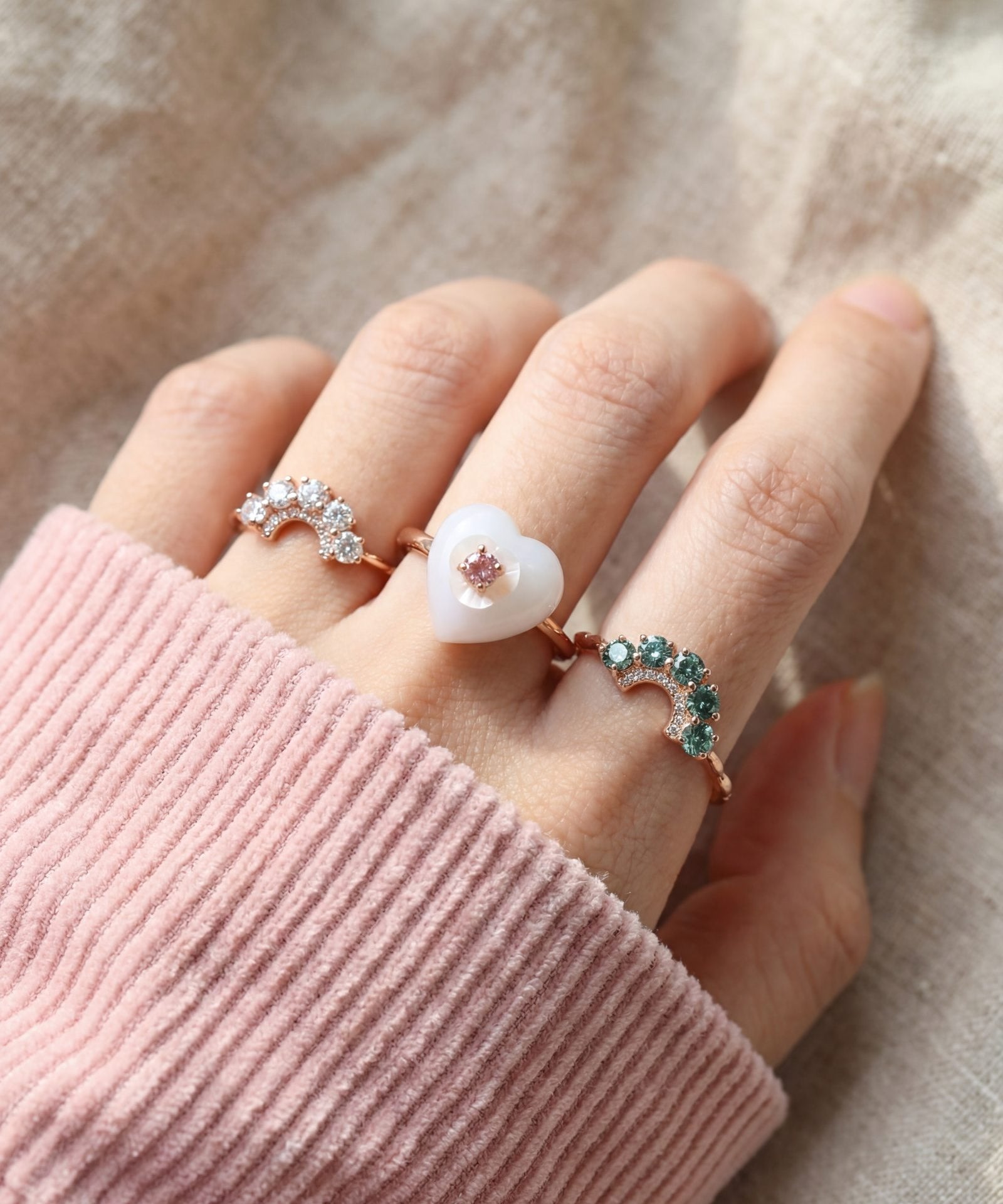 Arc Green Moissanite Ring in rose gold, worn on a model, alternate angle