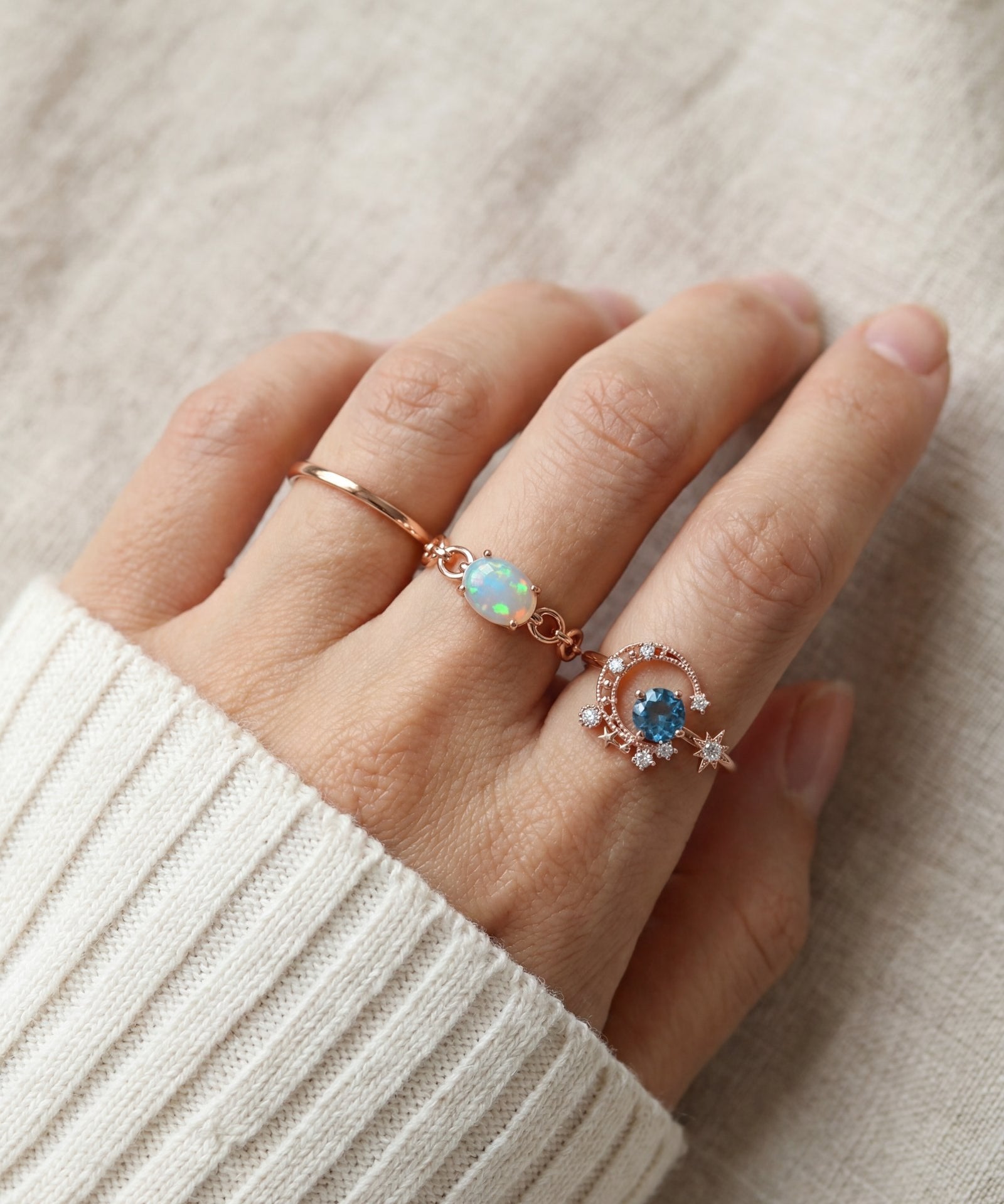 Astra Opal Ring in rose gold, worn on a model