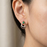 Lifestyle photo of a model wearing Aura Emerald Drop Studs in rose gold, highlighting the vibrant green natural emerald.