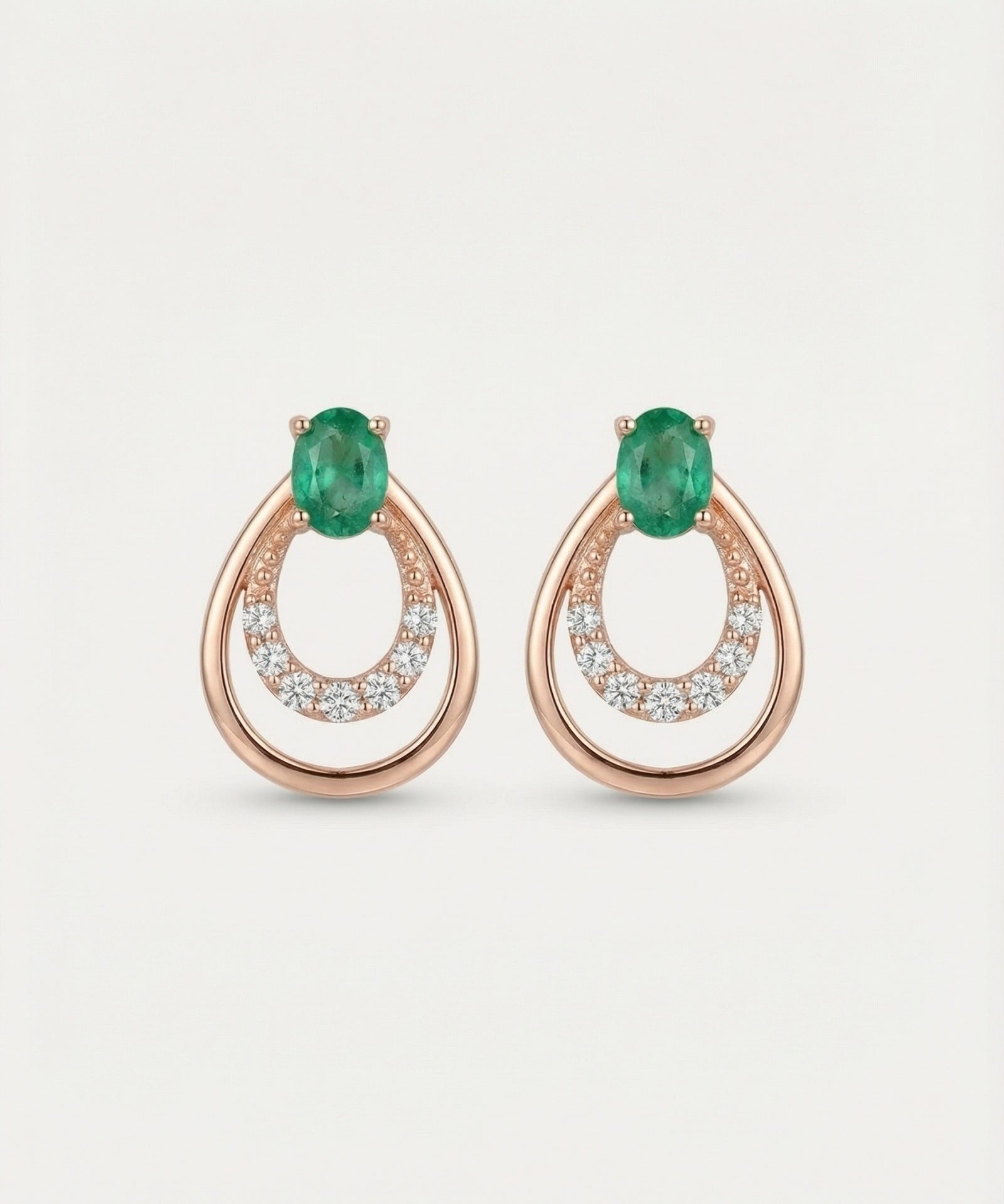 Professional product shot of Aura Emerald Drop Studs in Rose Gold with a clean white background.
