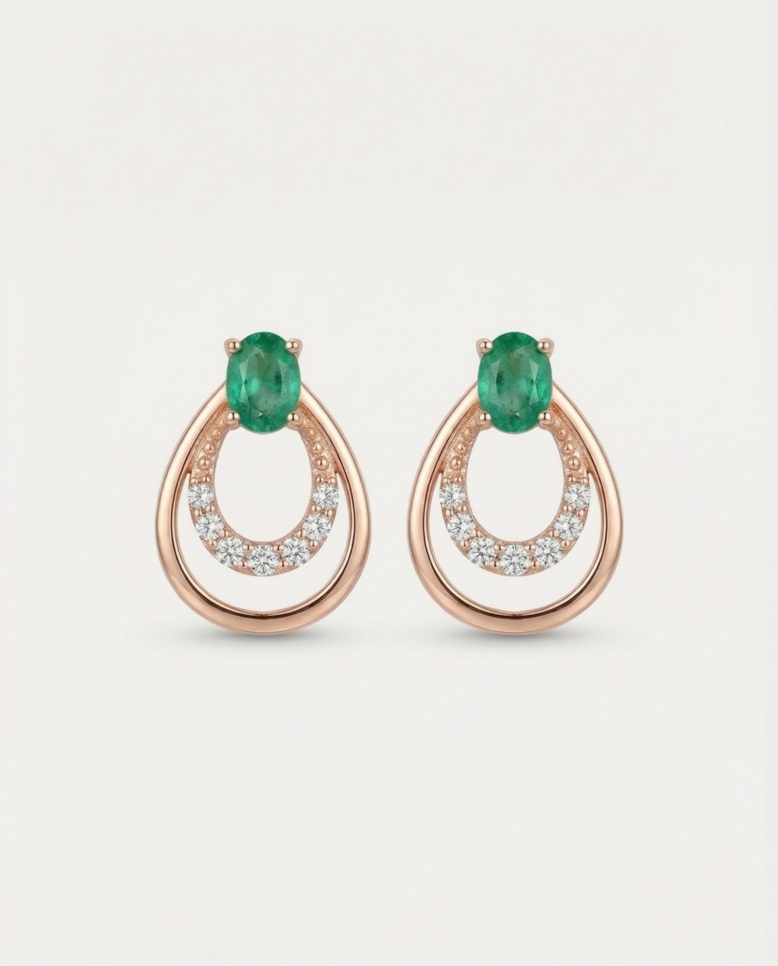 Professional product shot of Aura Emerald Drop Studs in Rose Gold with a clean white background.