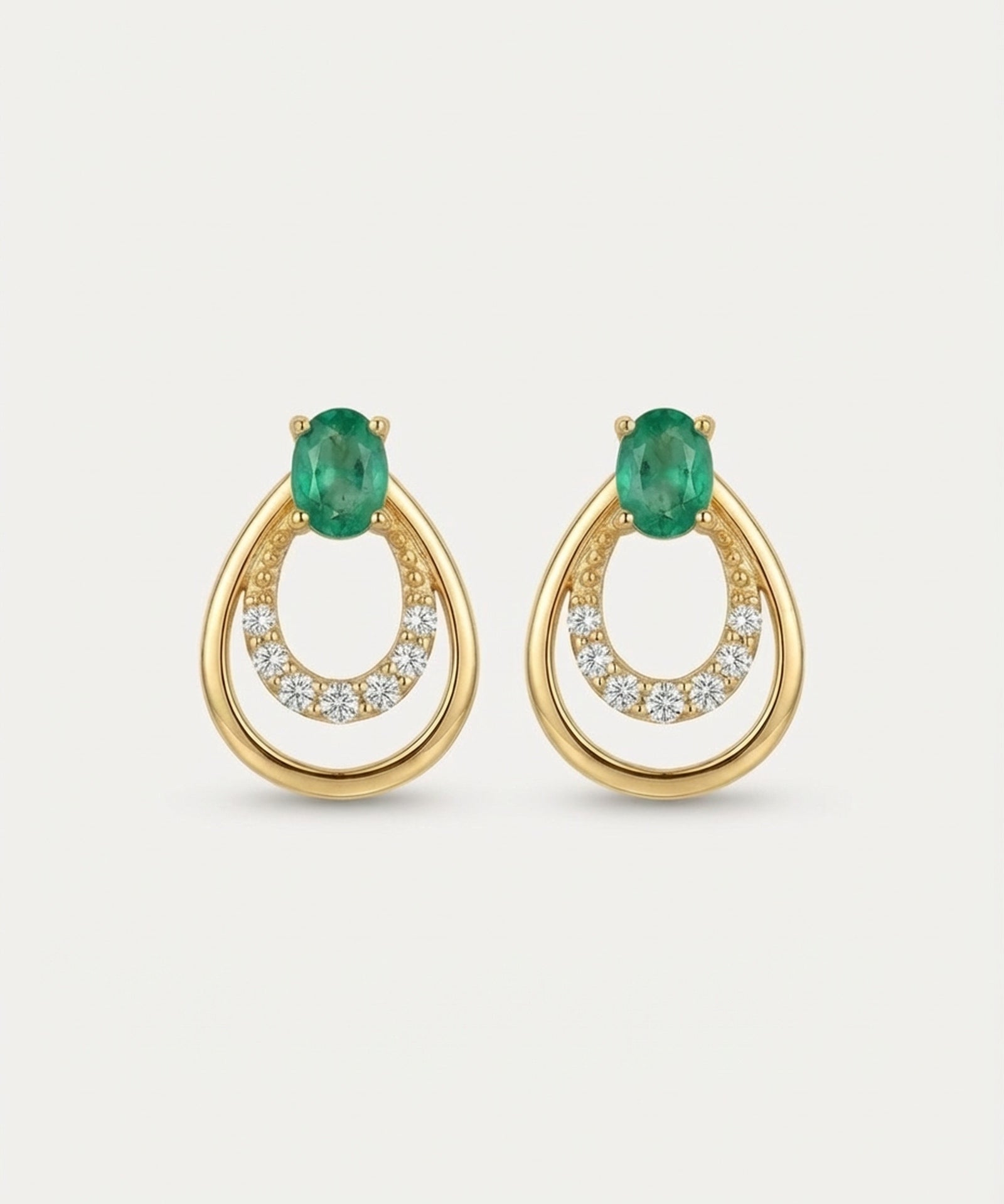 Professional product shot of Aura Emerald Drop Studs in Yellow Gold with a clean white background.