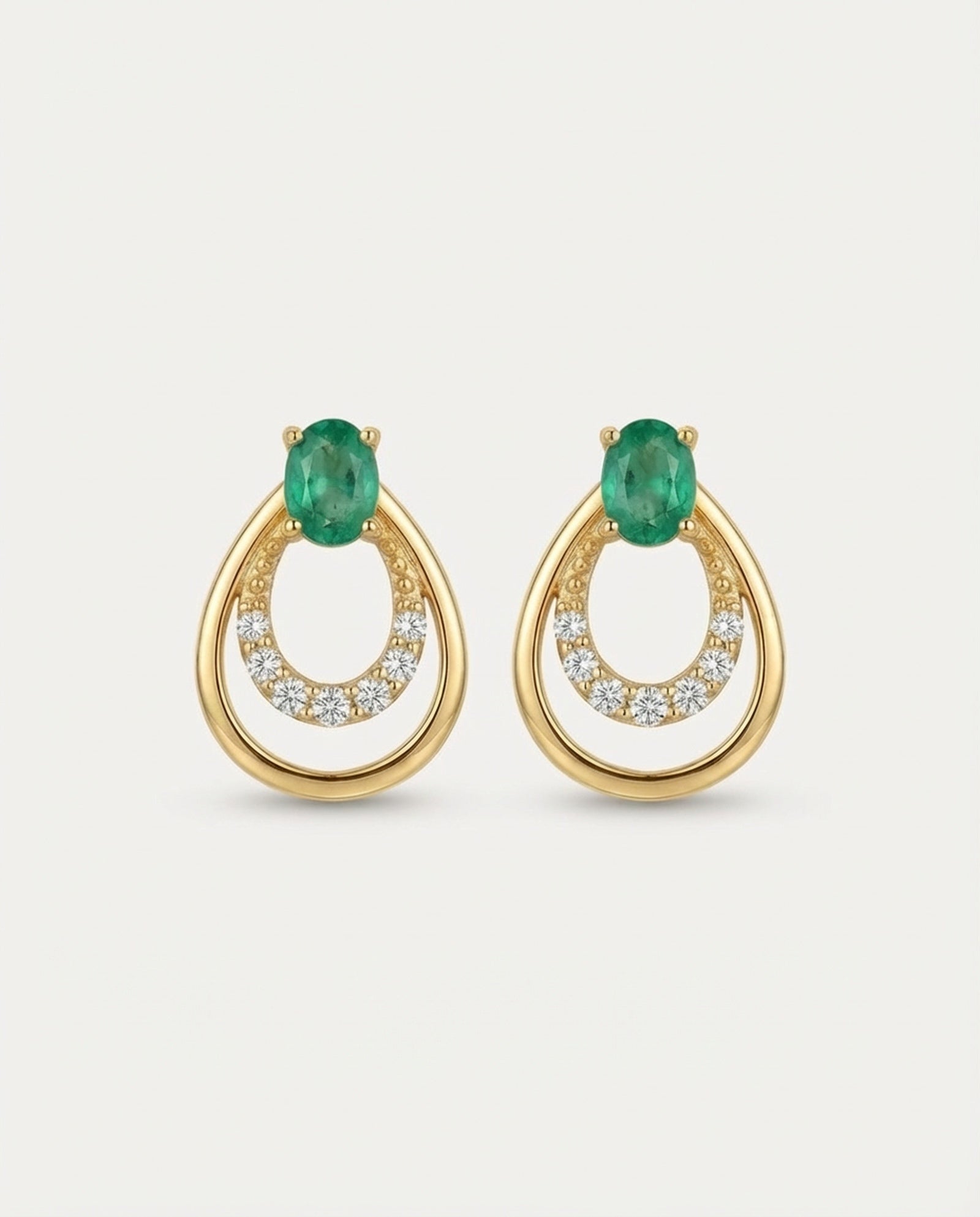 Professional product shot of Aura Emerald Drop Studs in Yellow Gold with a clean white background.