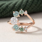 Aurora Crescent Moissanite Ring in rose gold, laid flat on a tabletop