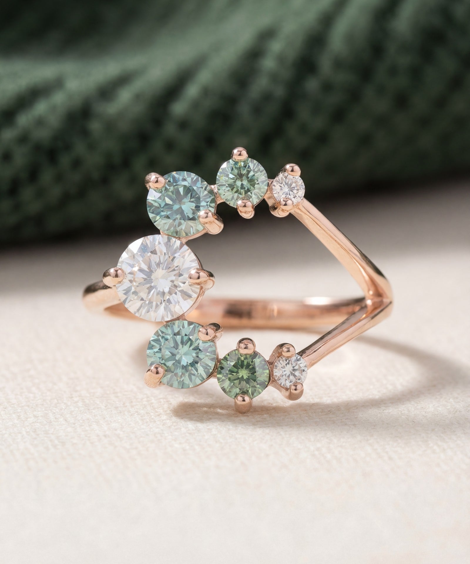 Aurora Crescent Moissanite Ring in rose gold, laid flat on a tabletop