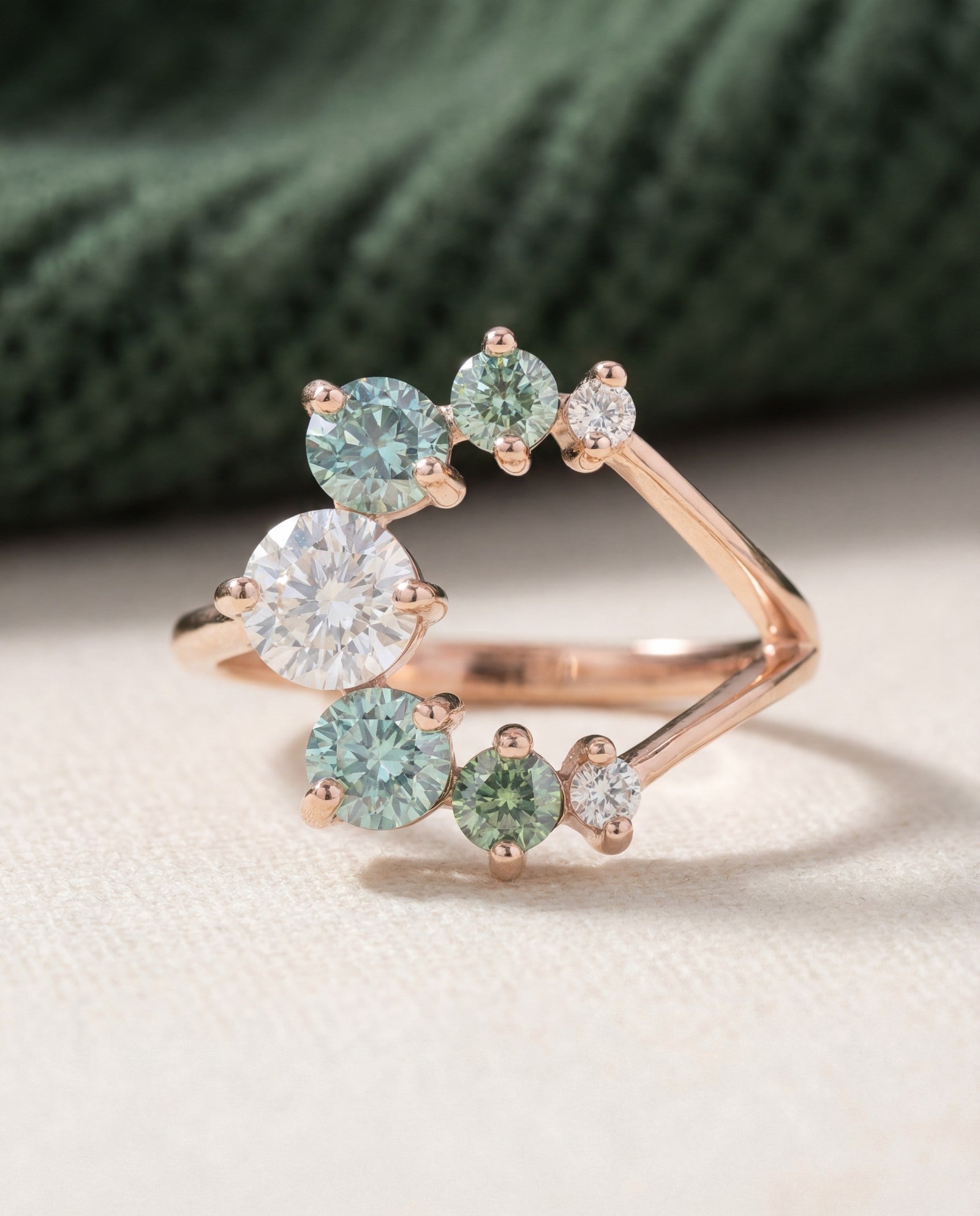 Aurora Crescent Moissanite Ring in rose gold, laid flat on a tabletop