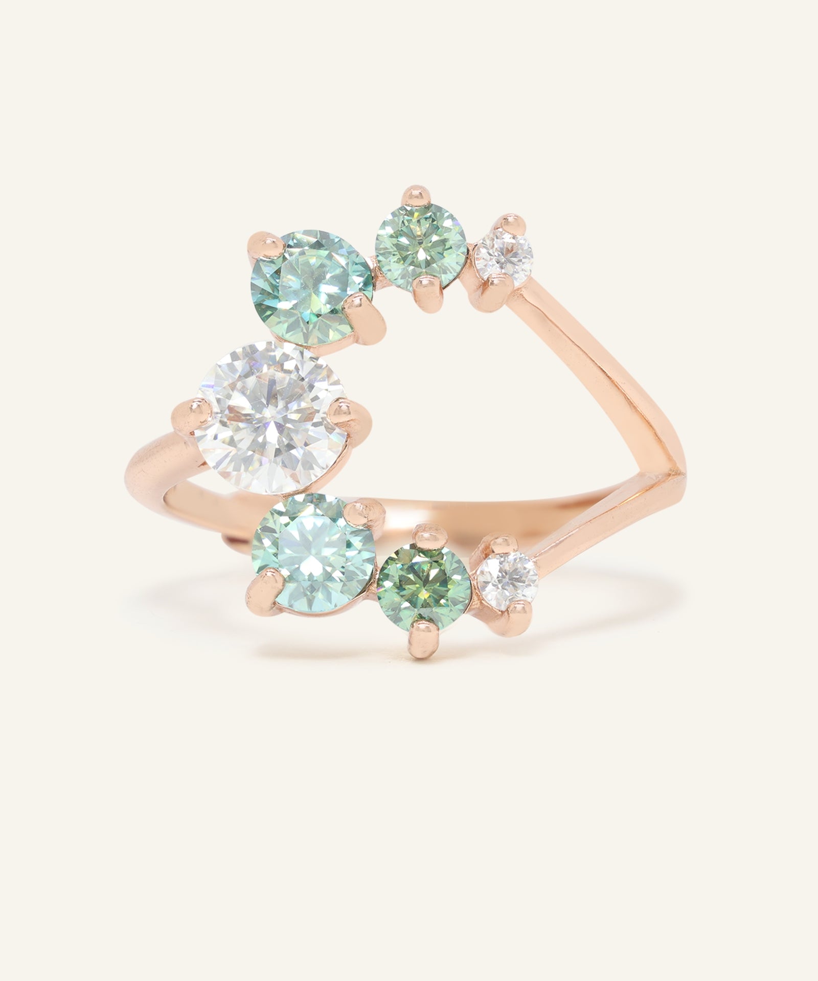 Aurora Crescent Moissanite Ring in rose gold, resting on a warm linen background