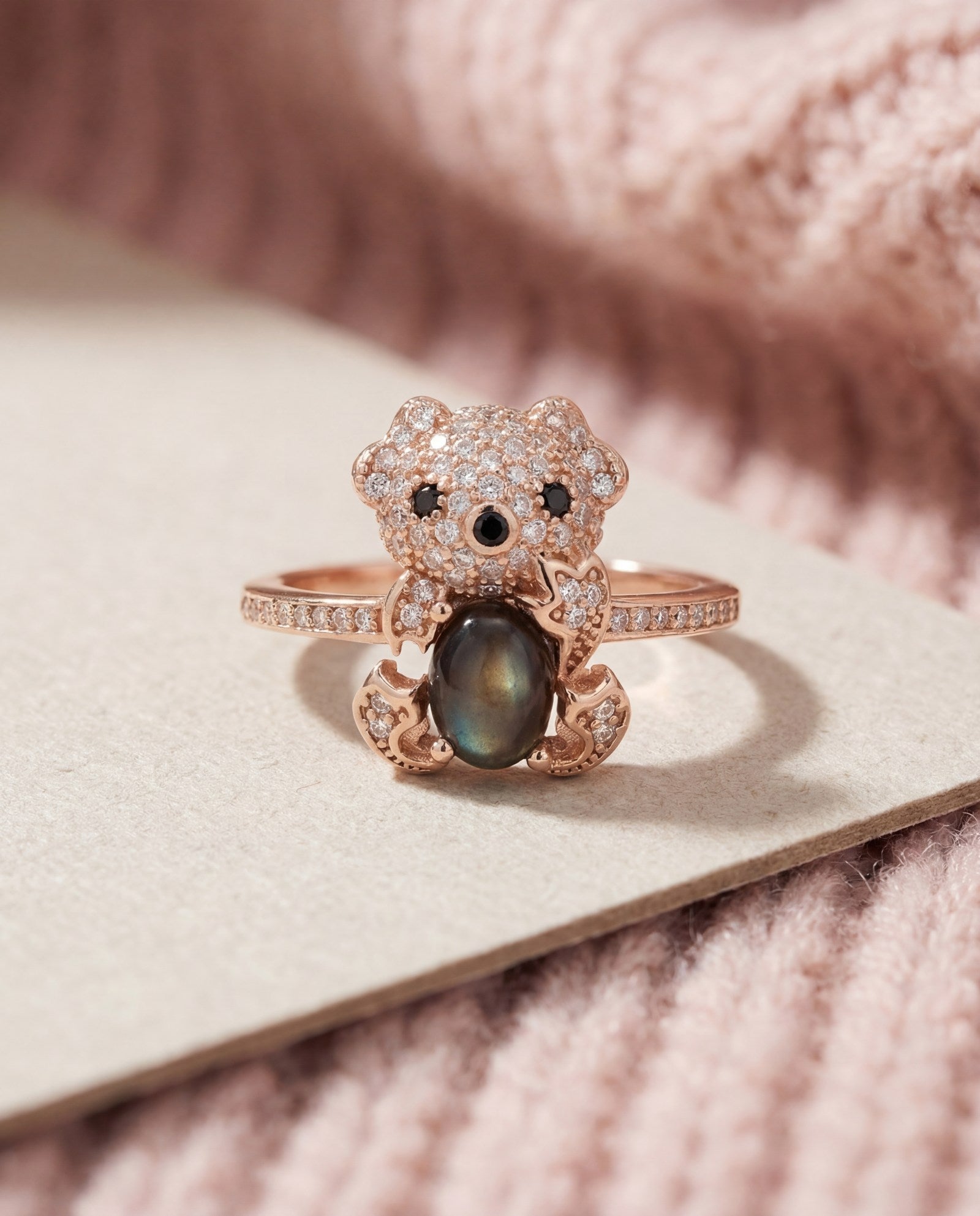 Black Sunstone Koala Bear Ring in rose gold, laid flat on a tabletop