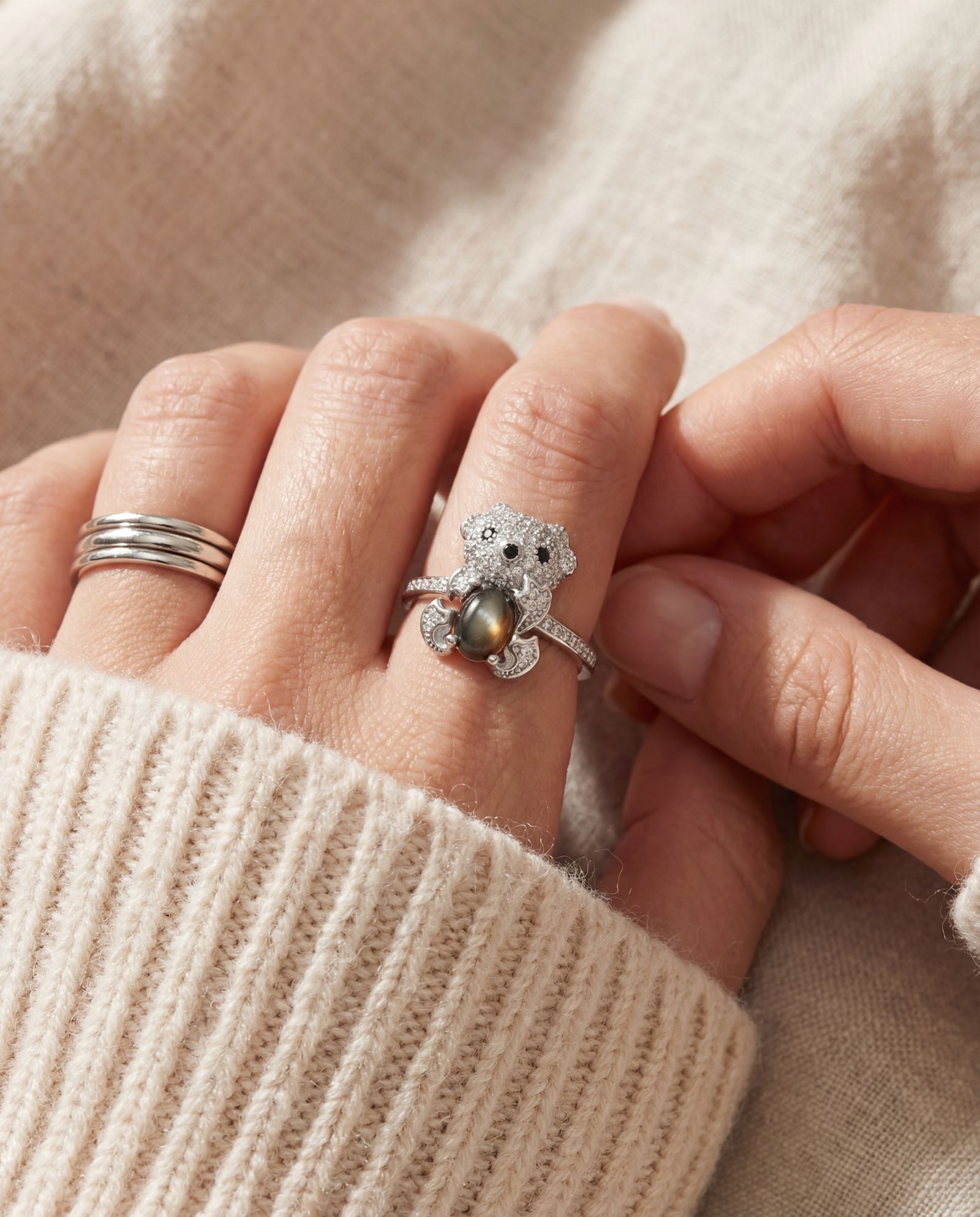Black Sunstone Koala Bear Ring in silver, worn on a model, stacked with other rings