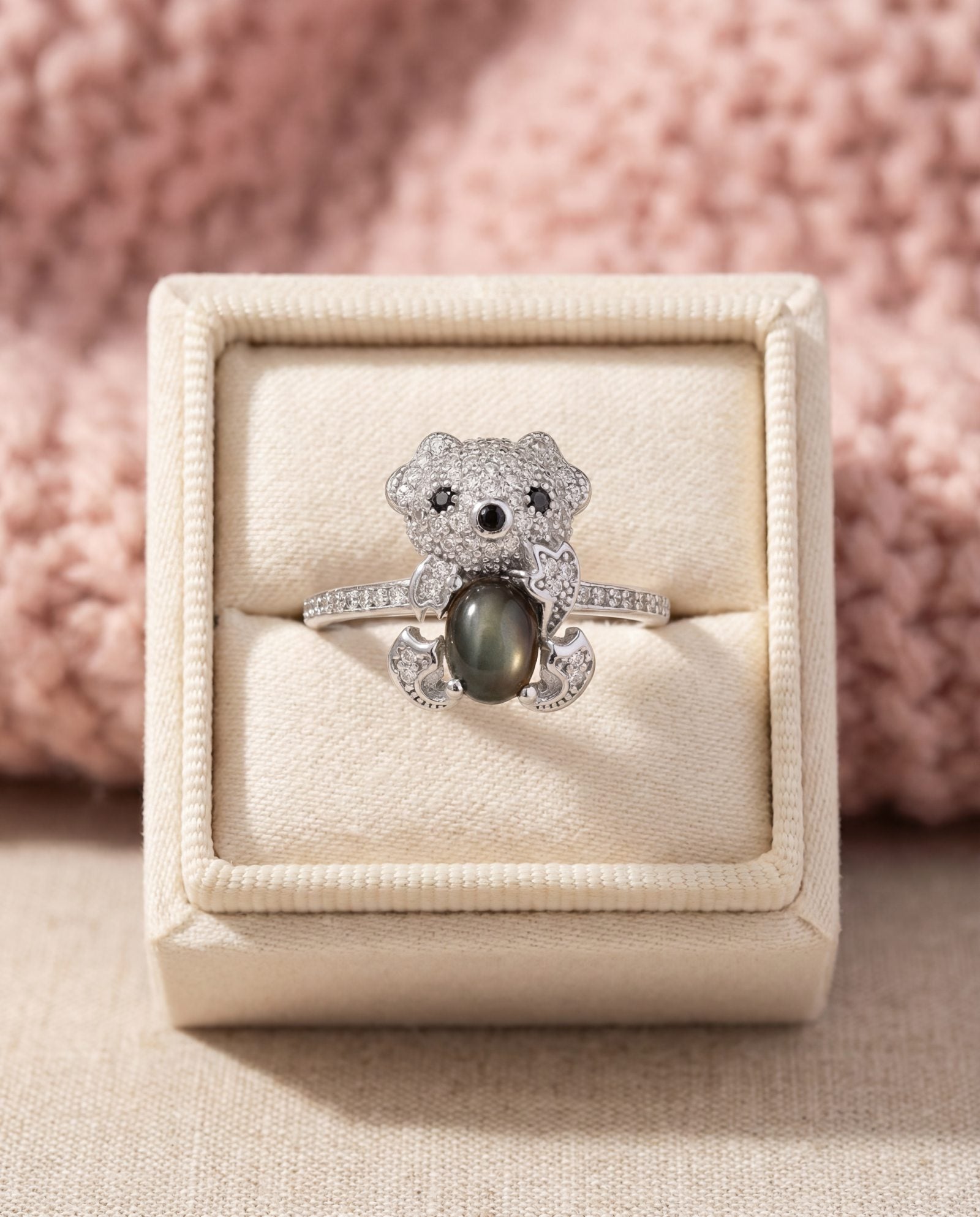 Black Sunstone Koala Bear Ring in silver, laid flat on a tabletop