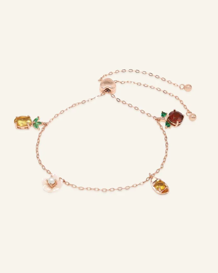 Rose gold slider bracelet featuring whimsical charms including a pineapple, orange, flower with pearl, and golden ingot, symbolizing blessings, wealth and joy.