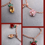Rose gold slider bracelet featuring whimsical charms including a pineapple, orange, flower with pearl, and golden ingot, symbolizing blessings, wealth and joy.