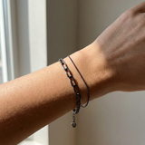 Boyfriend Curb Bracelet | Elate in black gold, worn on a model, stacked