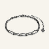 Boyfriend Curb Bracelet | Elate in black gold, resting on a warm linen background