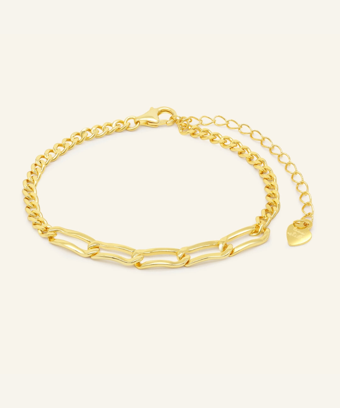 Close-up of the Boyfriend Curb Bracelet | Elate in yellow gold, resting on a warm linen background