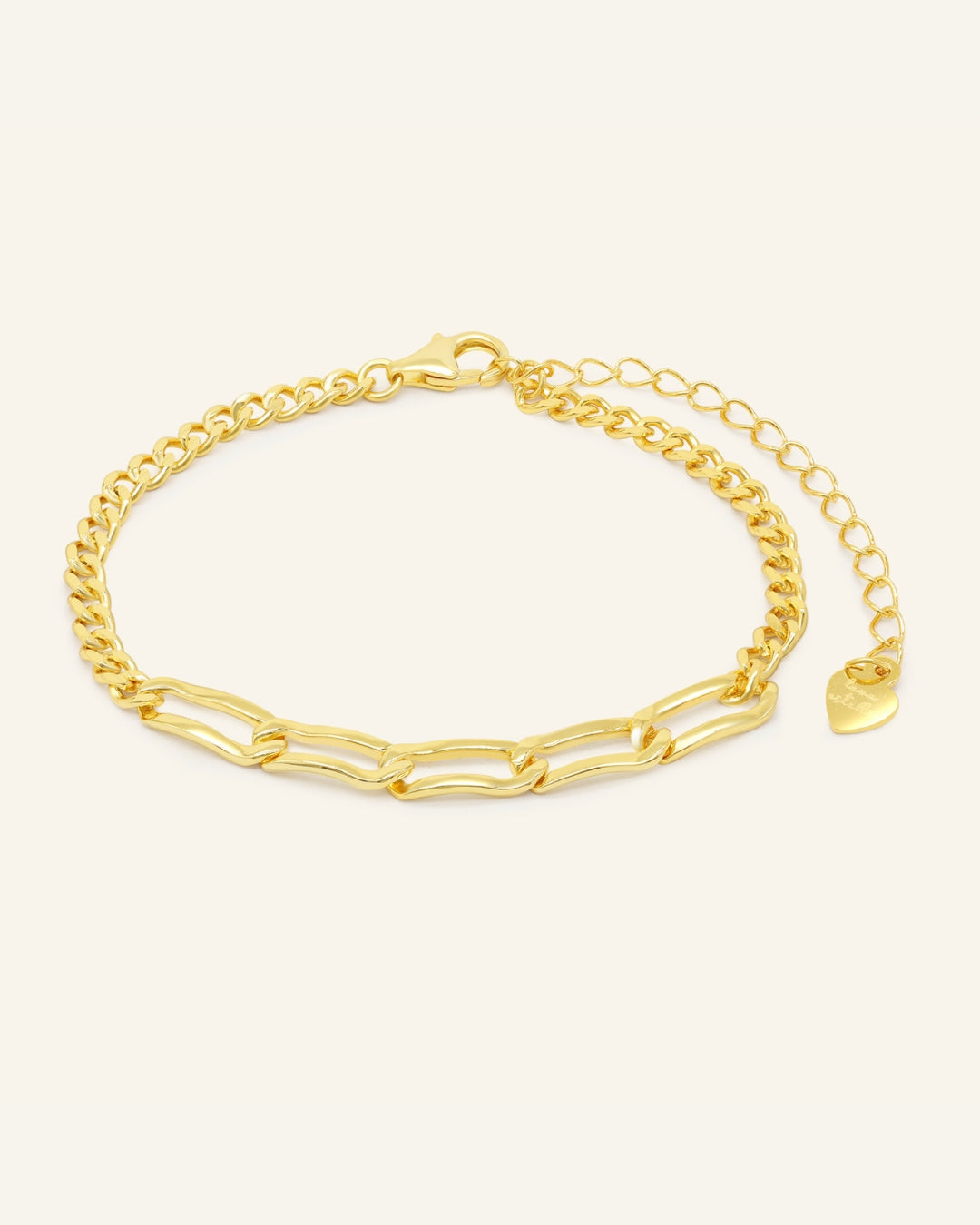 Close-up of the Boyfriend Curb Bracelet | Elate in yellow gold, resting on a warm linen background