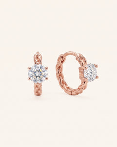 Pair of 18k rose gold vermeil Braided Moissanite Huggie Hoops featuring 0.5ct round white moissanite solitaire stones.