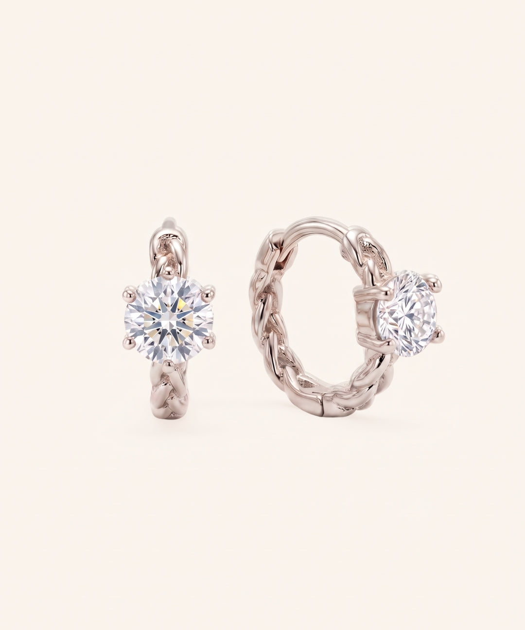 Pair of sterling silver Braided Moissanite Huggie Hoops featuring 0.5ct round white moissanite solitaire center stones.