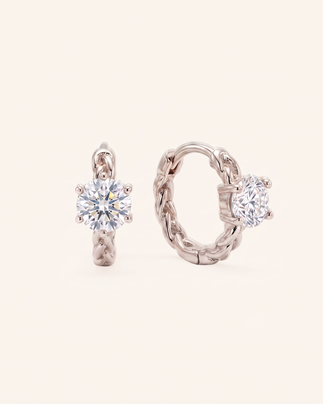 Pair of sterling silver Braided Moissanite Huggie Hoops featuring 0.5ct round white moissanite solitaire center stones.