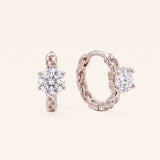 Pair of sterling silver Braided Moissanite Huggie Hoops featuring 0.5ct round white moissanite solitaire center stones.