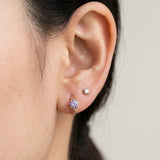 Model wearing a rose gold vermeil Braided Lavender Moissanite Huggie Hoop (1ctw) in the first lobe piercing.