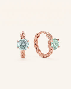Pair of 18k rose gold vermeil Braided Mint Moissanite Huggie Hoops with 0.5ct round pastel green moissanite solitaire center stones.