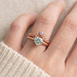 Model wearing a rose gold vermeil Braided Wishbone Lavender Moissanite Ring stacked above a large heart-cut moissanite solitaire ring.