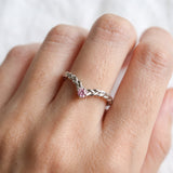 Model wearing a sterling silver Braided Wishbone Pink Moissanite Ring worn solo on index finger.