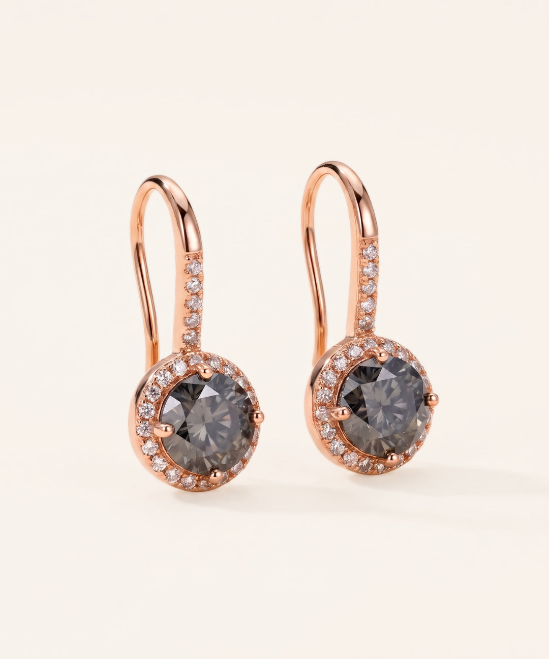 Pair of 18k rose gold Candlelight Halo Moissanite Ear Hooks with 1-carat round Twilight Grey moissanite center stones and pavé wire detail.