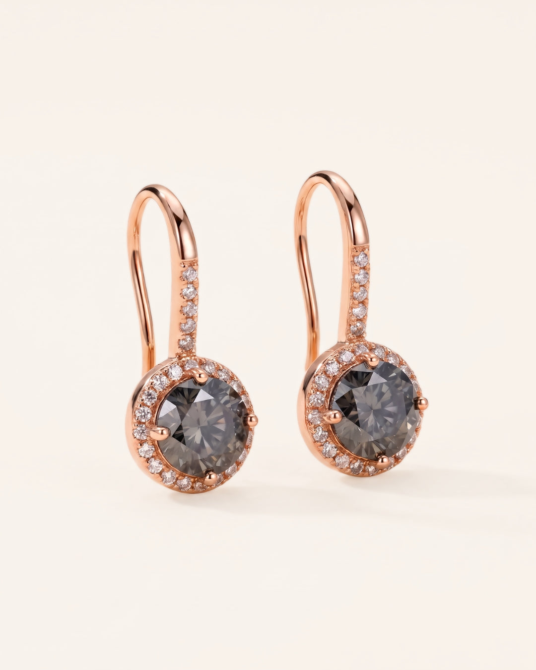 Pair of 18k rose gold Candlelight Halo Moissanite Ear Hooks with 1-carat round Twilight Grey moissanite center stones and pavé wire detail.