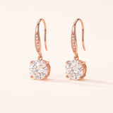 Studio pair shot of 18k rose gold Candlelight Moissanite Solitaire Hooks featuring 2-carat round off-white stones.