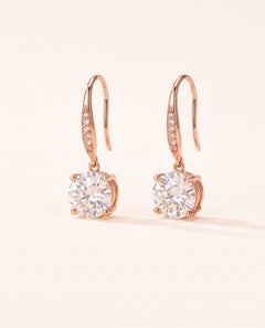 Studio pair shot of 18k rose gold Candlelight Moissanite Solitaire Hooks featuring 2-carat round off-white stones.