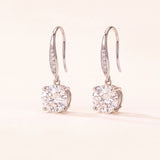 Studio pair shot of 925 sterling silver Candlelight Moissanite Solitaire Hooks with pavé wire details.