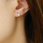 white topaz heart ear studs on model